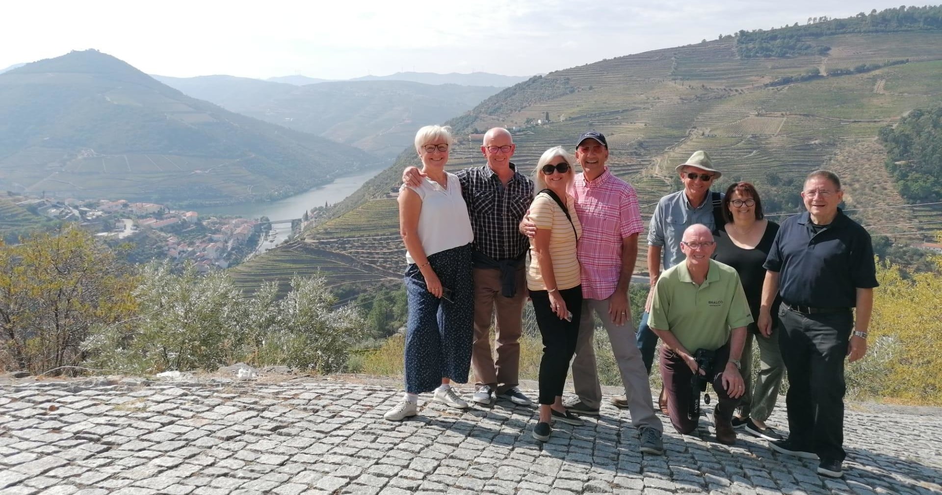 Private Tour – Douro Valley: 2 Wineries and Lunch Image 1 a group of people standing in front of a mountain