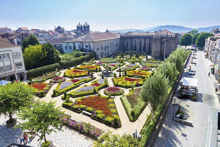 a garden with a city in the background