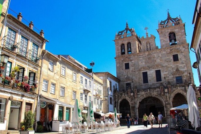 a group of people walking in front of a church