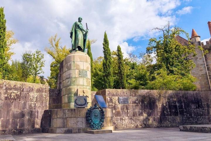 a stone building that has a sign on a rock