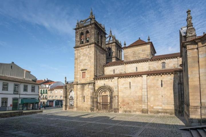 a stone church with a clock on the side of a building